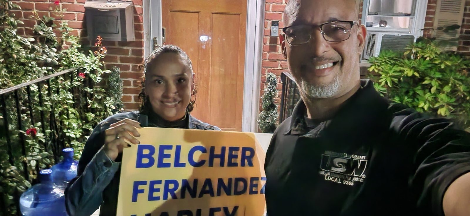 George Fernandez Jr. and a supporter holding a Teaneck First yard sign