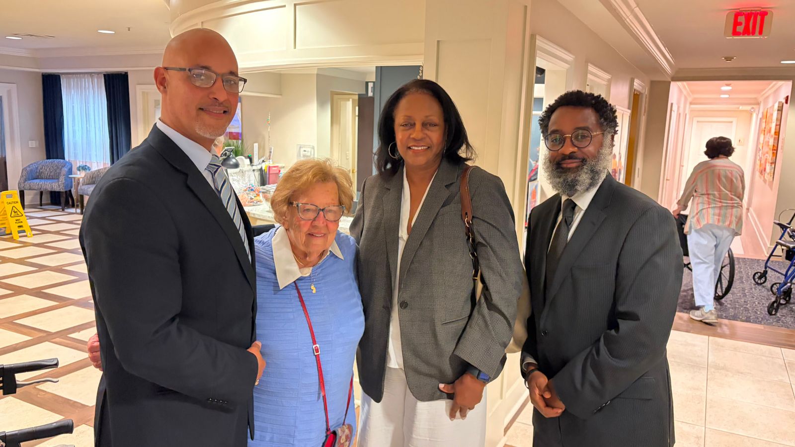 Deputy Mayor Denise Belcher and Duane Harley with residents during a visit to a Teaneck senior residence