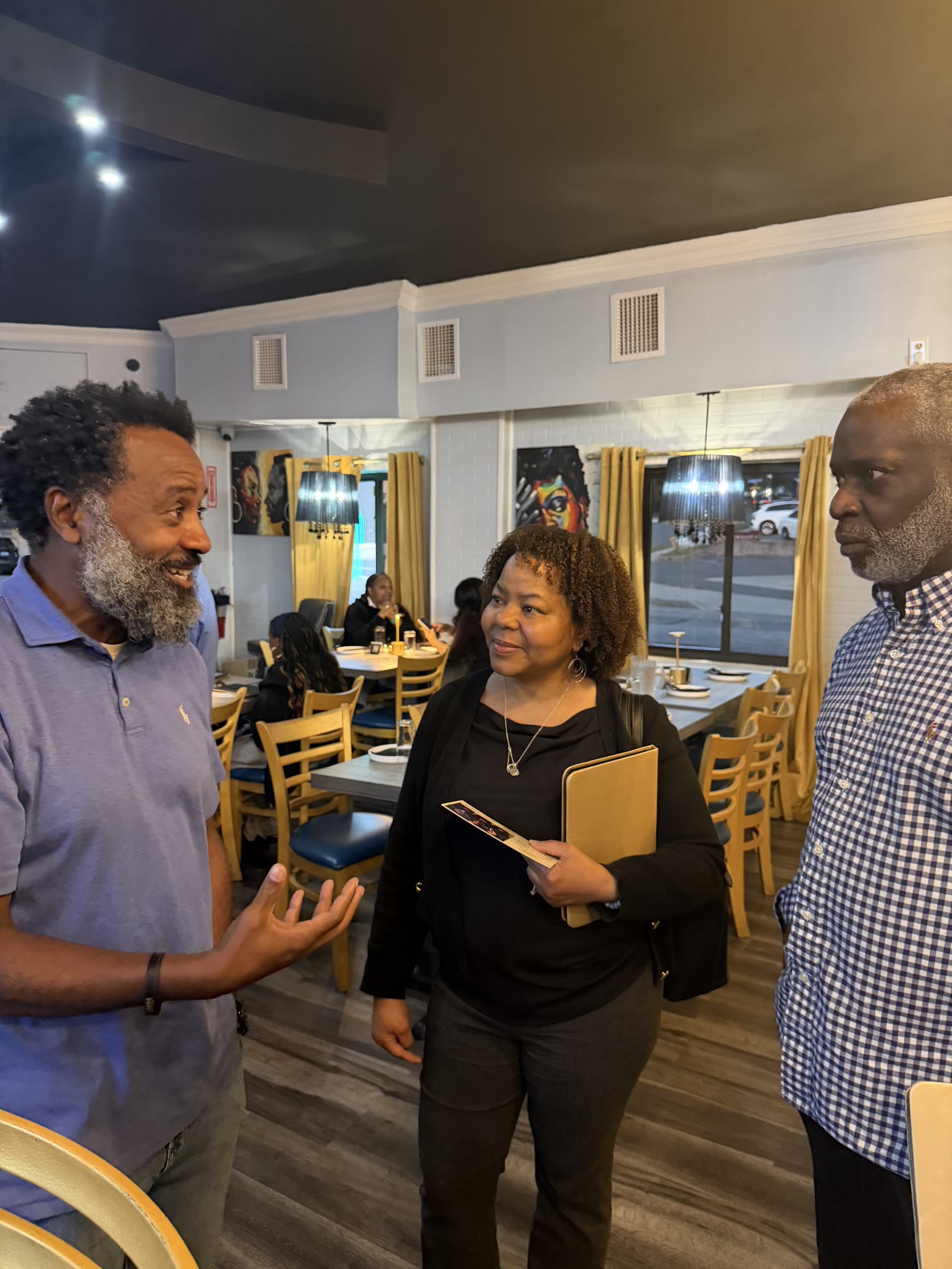 George Fernandez Jr. in conversation with residents at a local restaurant